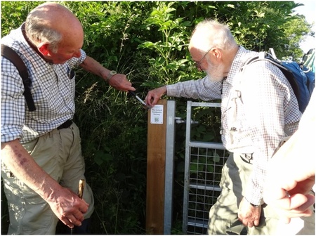 Michael Payton and John Eyre affixing a plaque at a Garsington gate